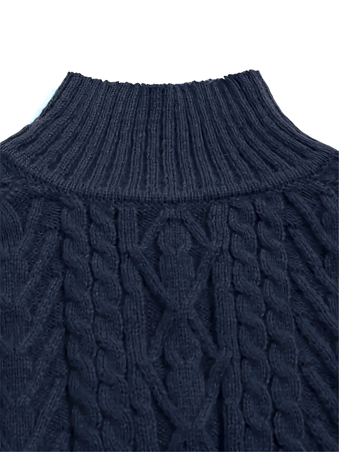 Close-up of a navy blue cable knit sweater on a white background