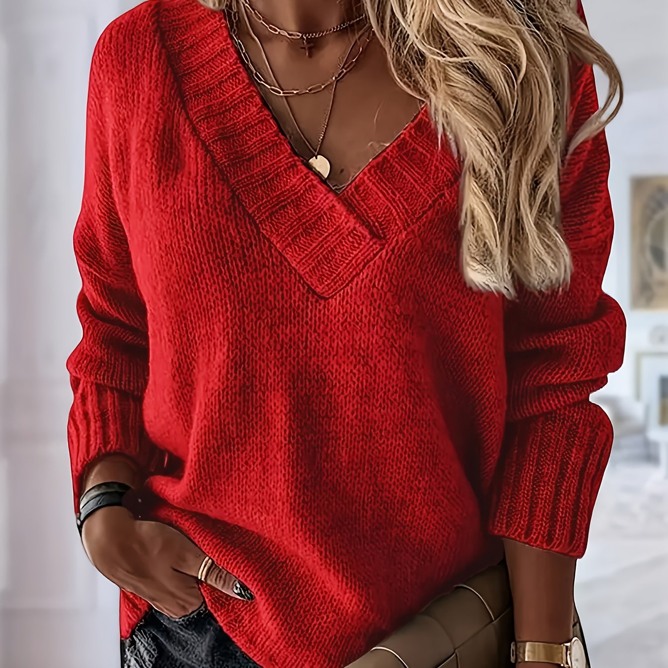 Person wearing a red sweater with a blurred background