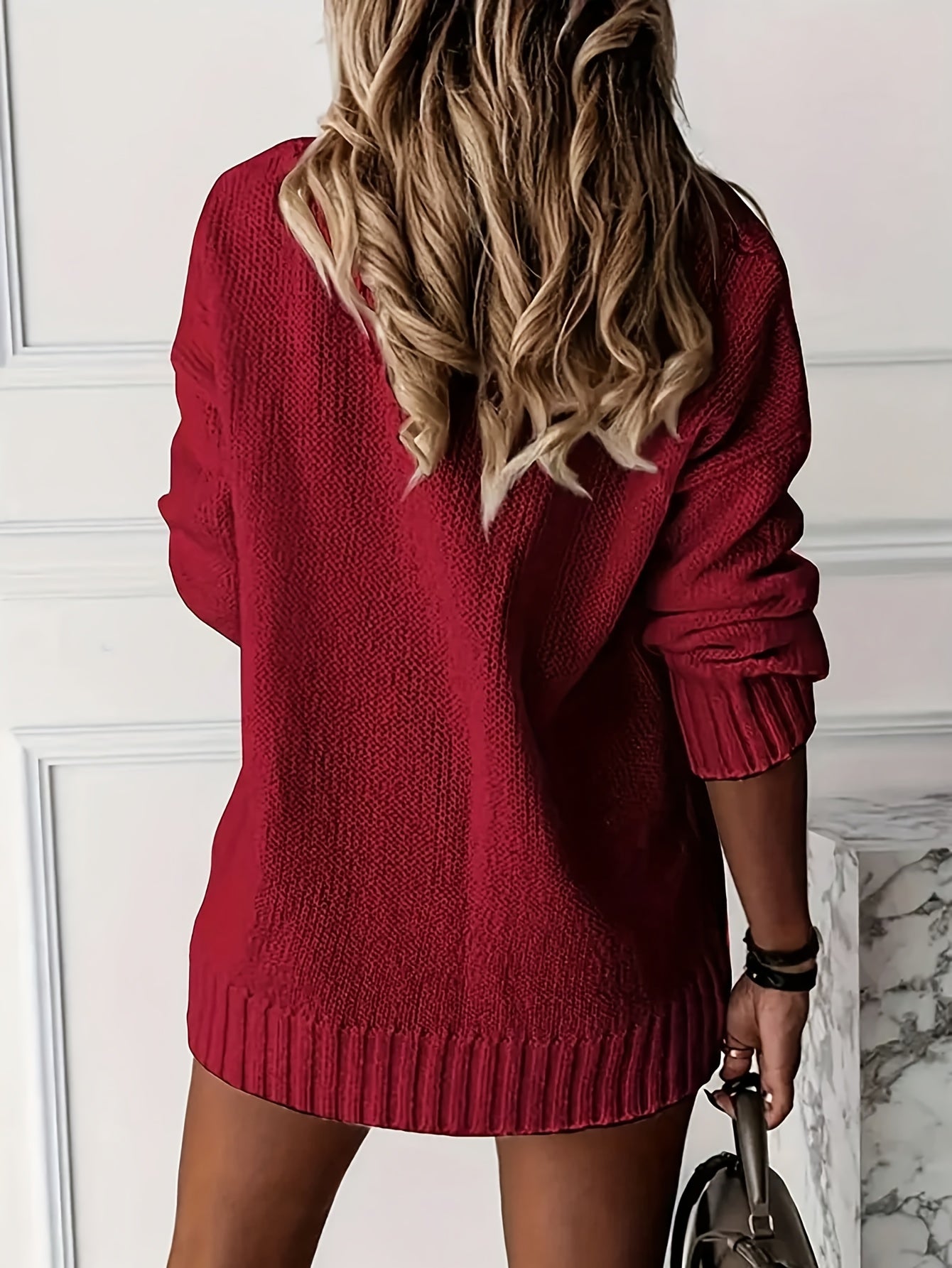 Red sweater dress worn by a person with a neutral background