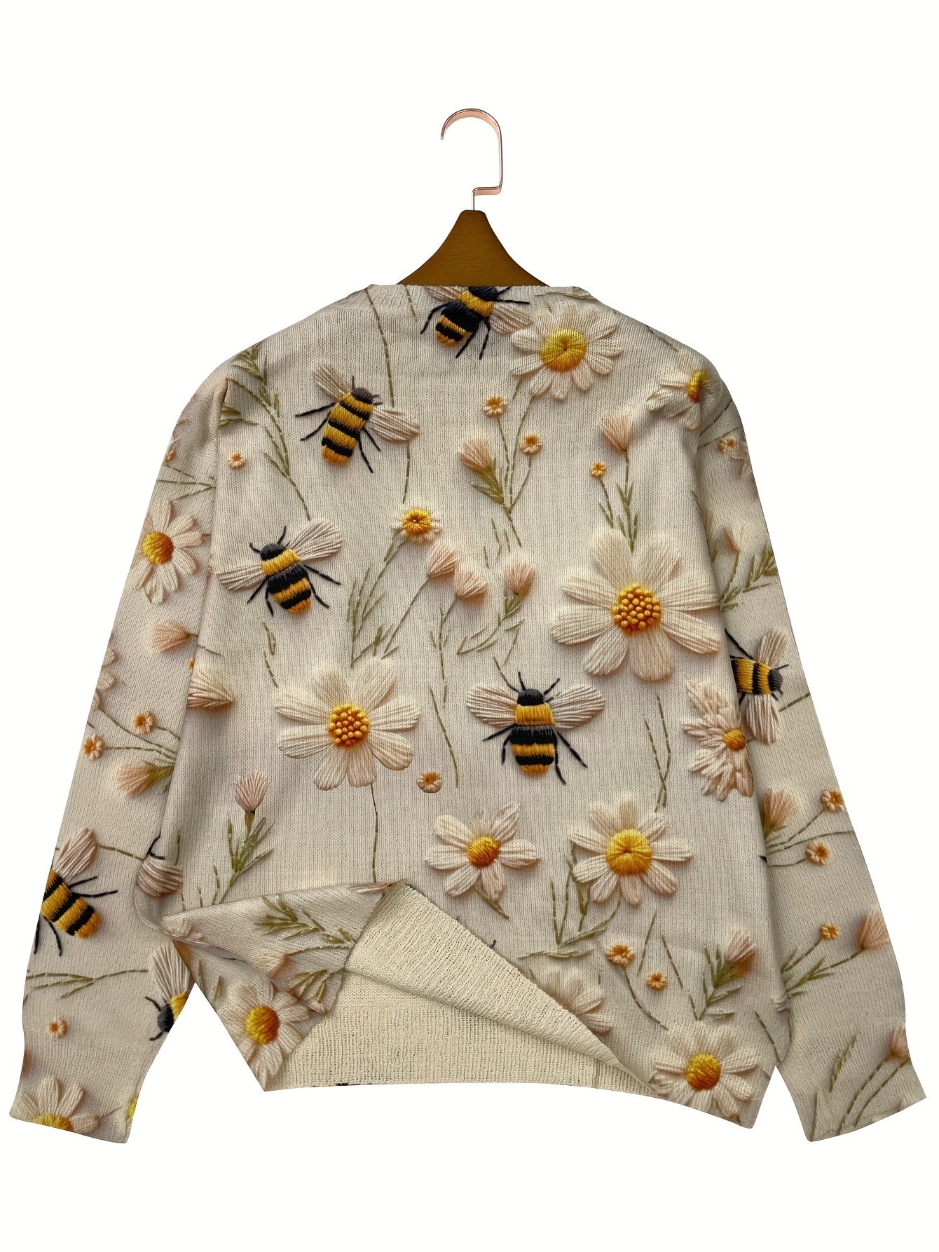 Sweater with floral and bee pattern on a hanger
