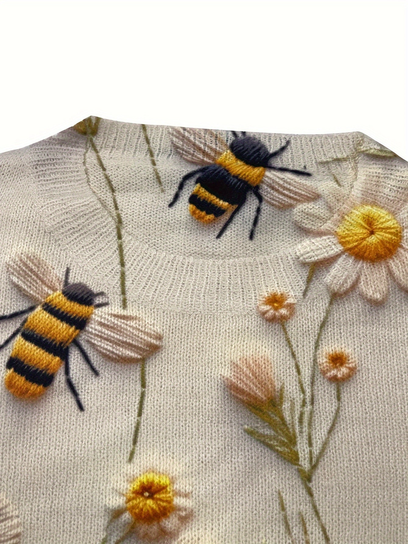 Knitted fabric with embroidered bees and flowers on a beige background