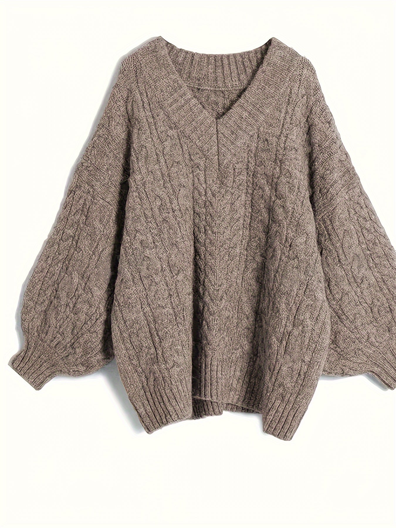 Brown cable knit sweater on a white background