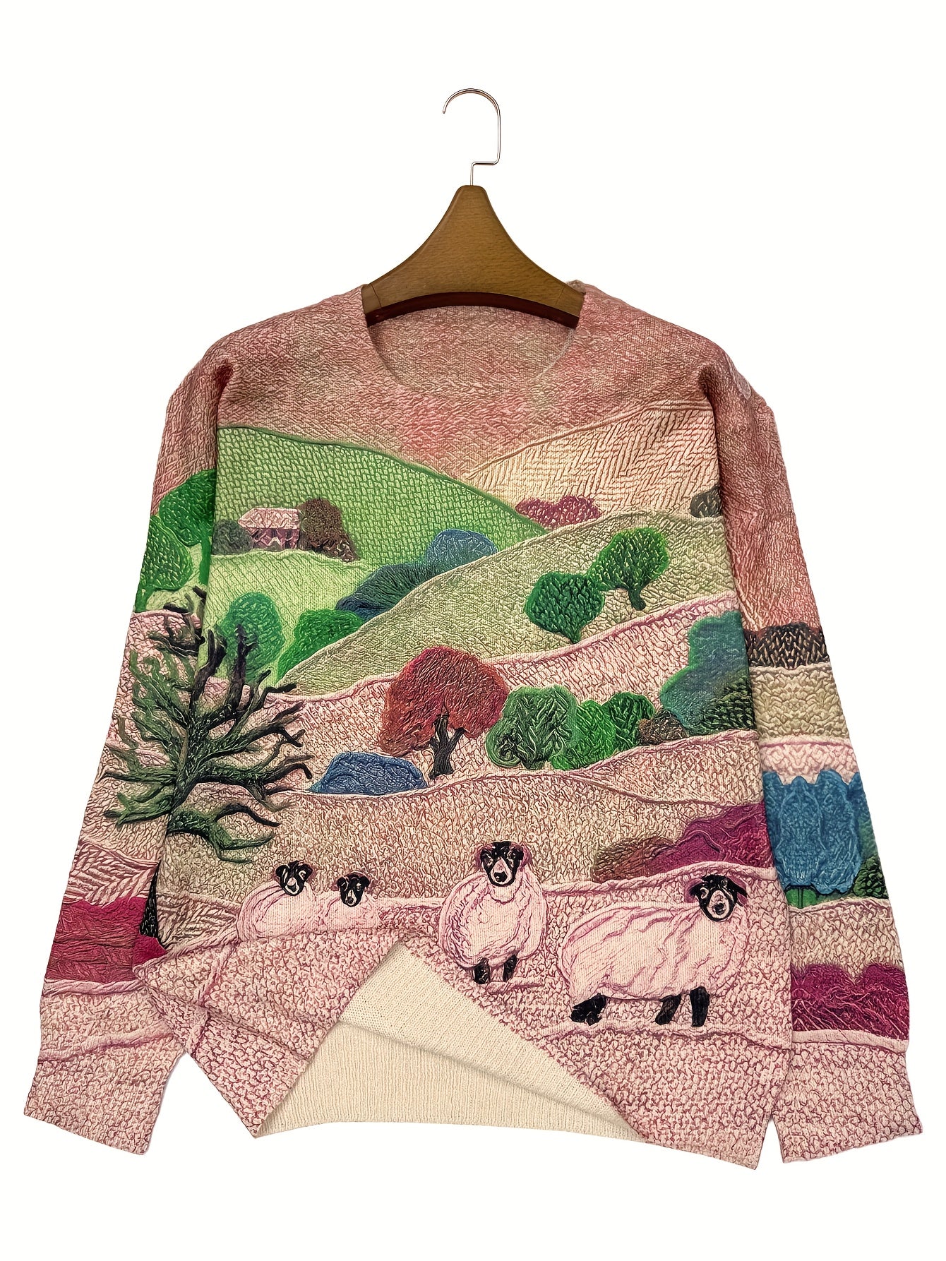 Sweater with embroidered landscape design featuring sheep and trees on a hanger.
