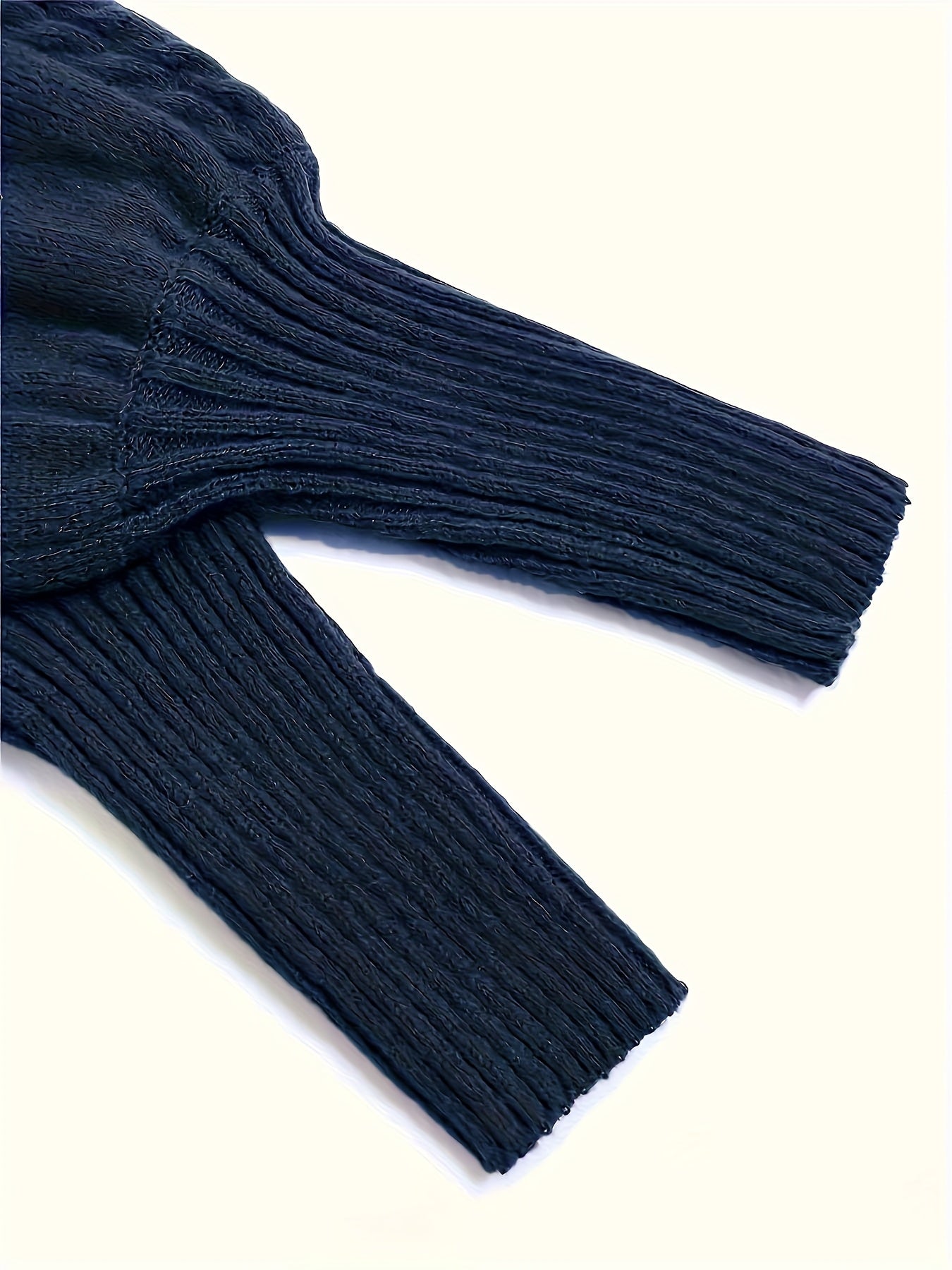 Navy blue ribbed sweater on a white background