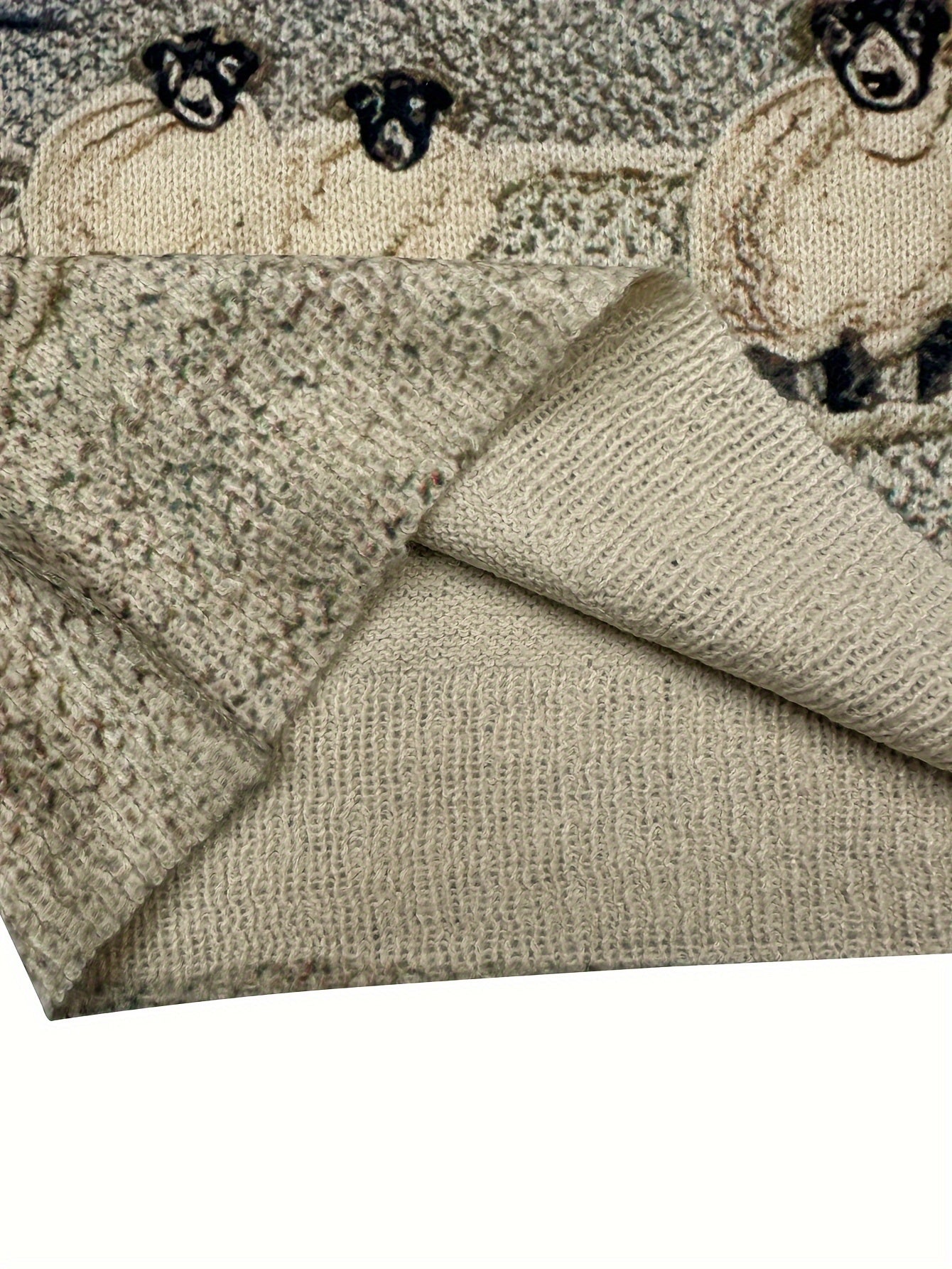 Textured fabric with embroidered sheep design on a white background