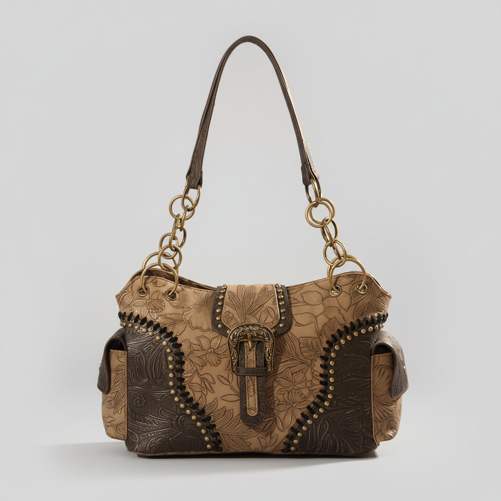Brown leather handbag with intricate designs on a wooden surface