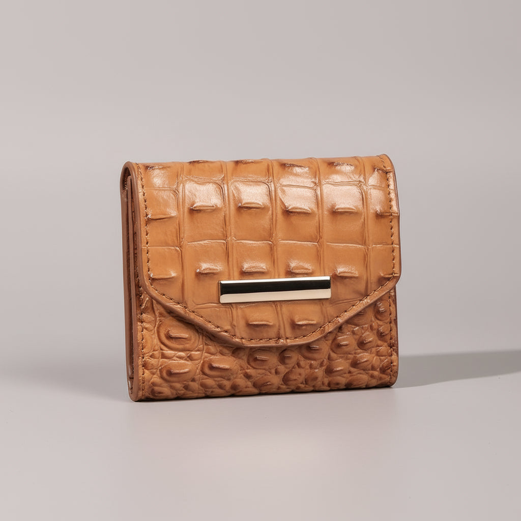 Brown textured wallet on a textured surface with a dark background