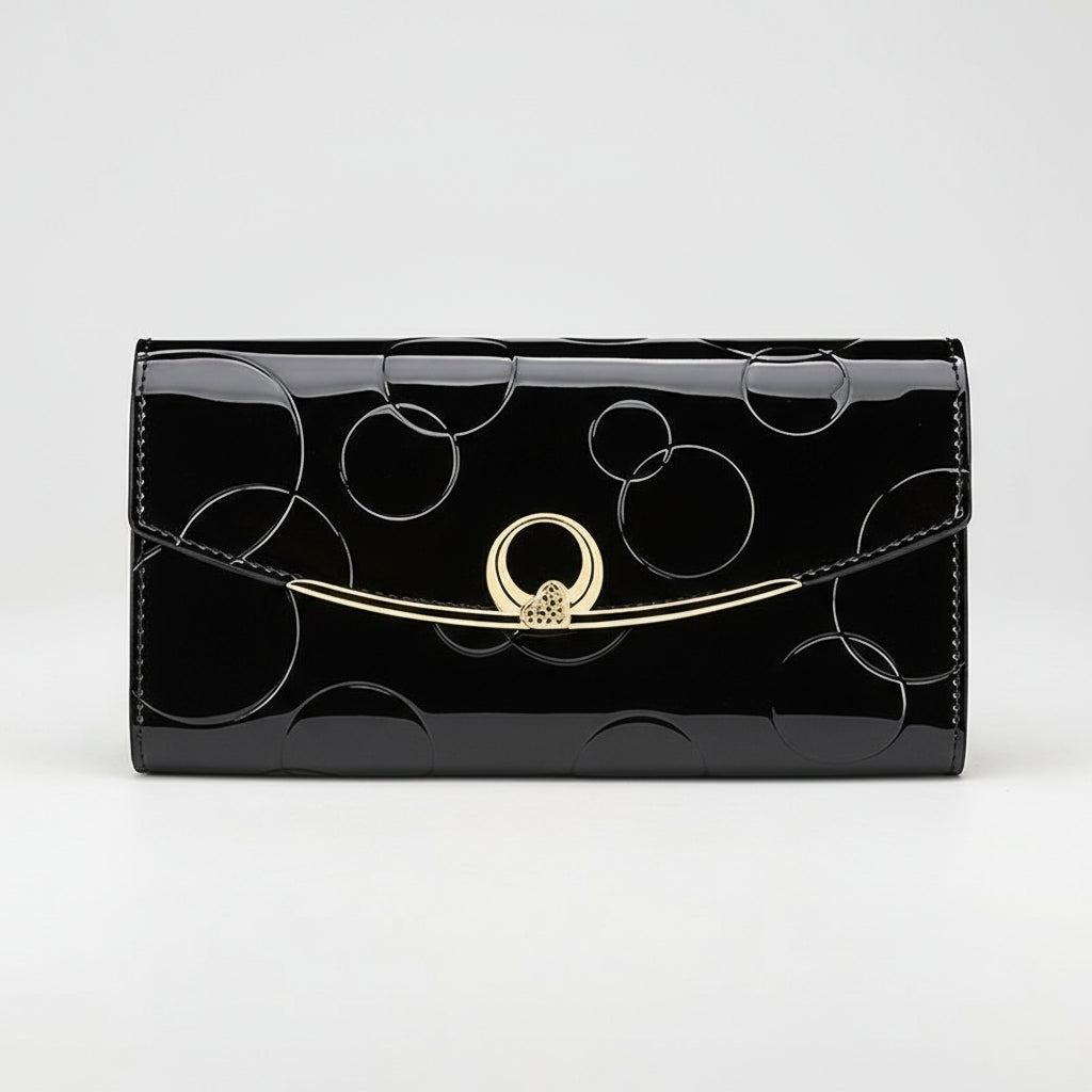 Black patent leather wallet with gold clasp on a white background