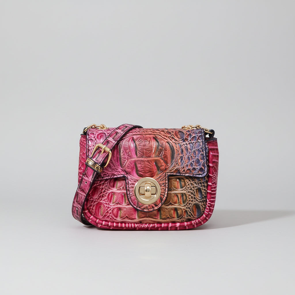Pink textured handbag on a wooden surface with a random cut fabric pattern inset.