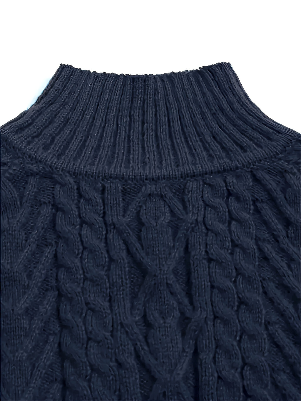 Close-up of a navy blue cable knit sweater on a white background