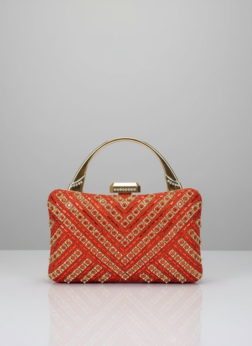 Handbag with gold chain details held by a hand against a neutral background