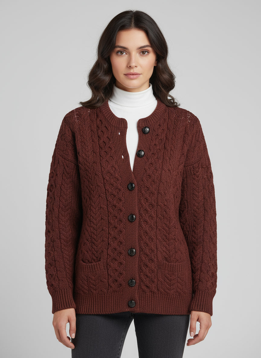 Brown knitted cardigan with button details worn by a person, blurred background