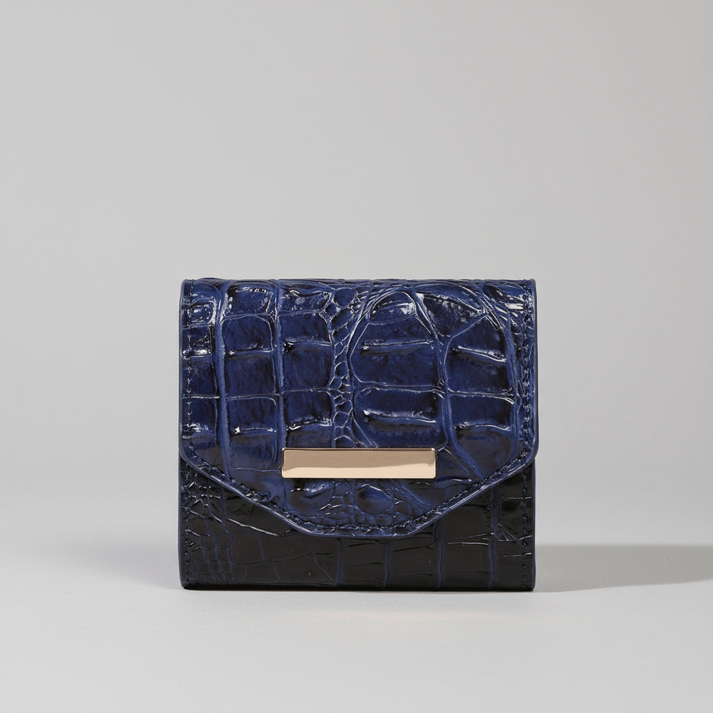 Blue textured wallet with gold clasp on a light surface