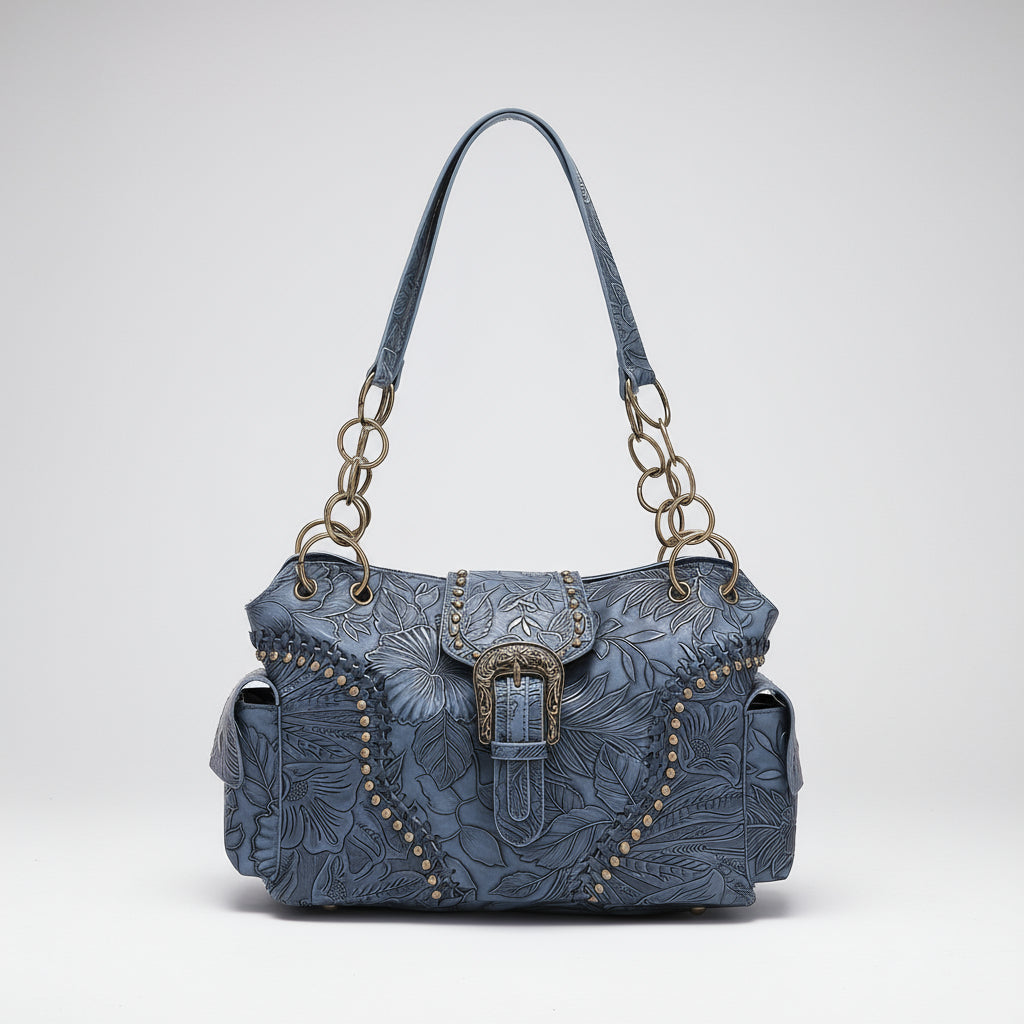 Blue textured handbag with decorative buckle on a white background