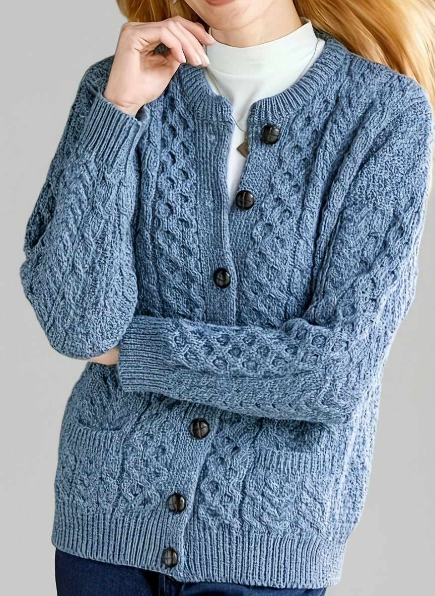Person wearing a blue knitted cardigan with button details.