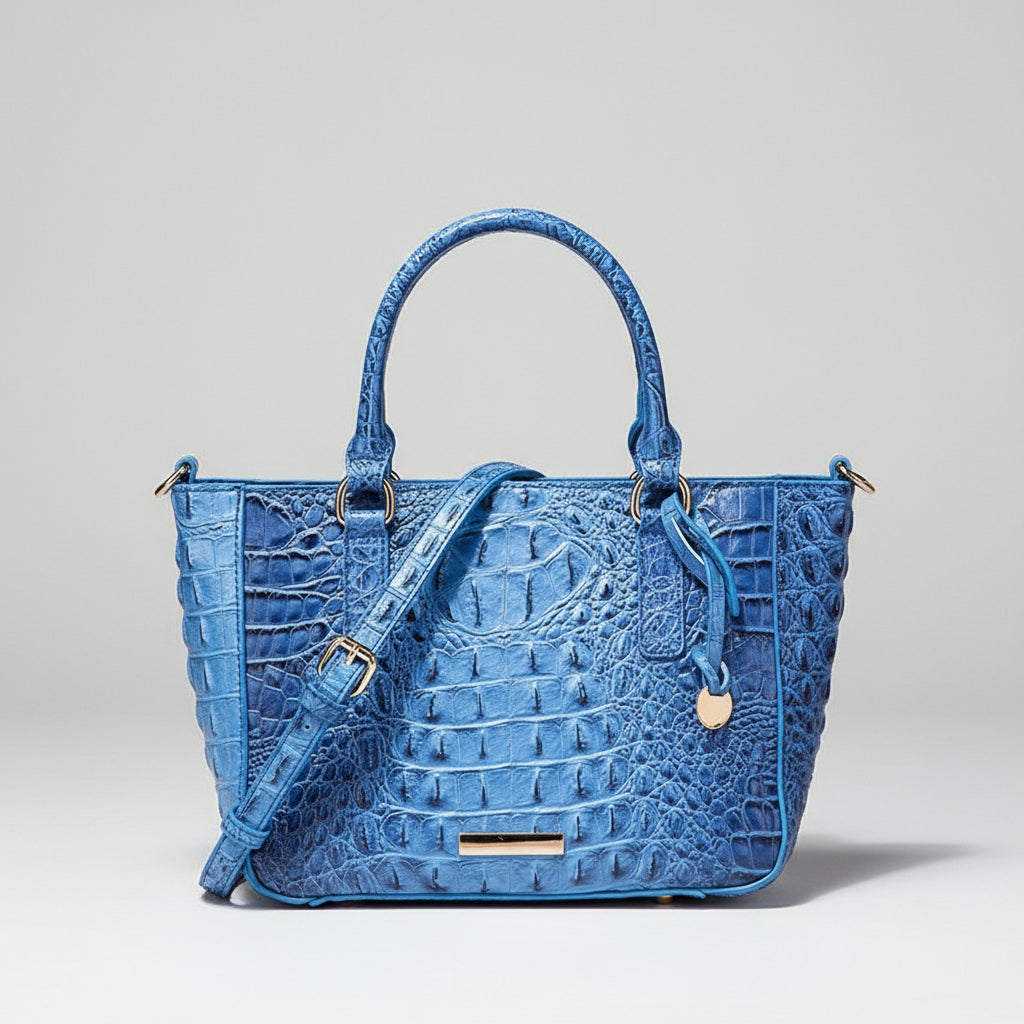 Blue textured handbag with a strap on a dark background