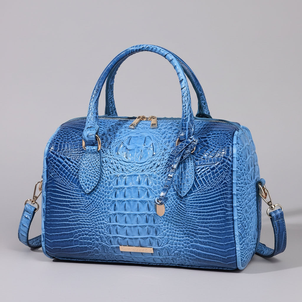 Blue textured handbag on a wooden surface with a dark background