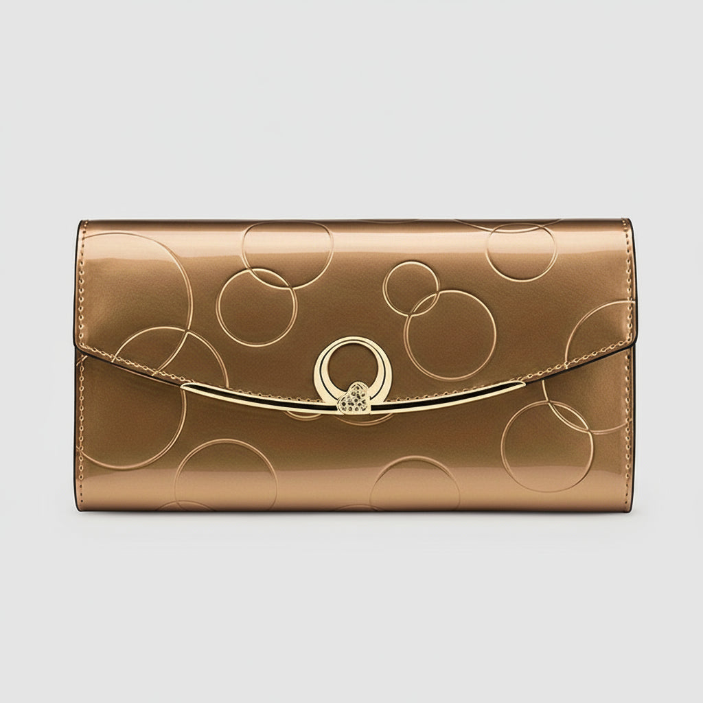 Gold wallet with circular design and clasp on a white background