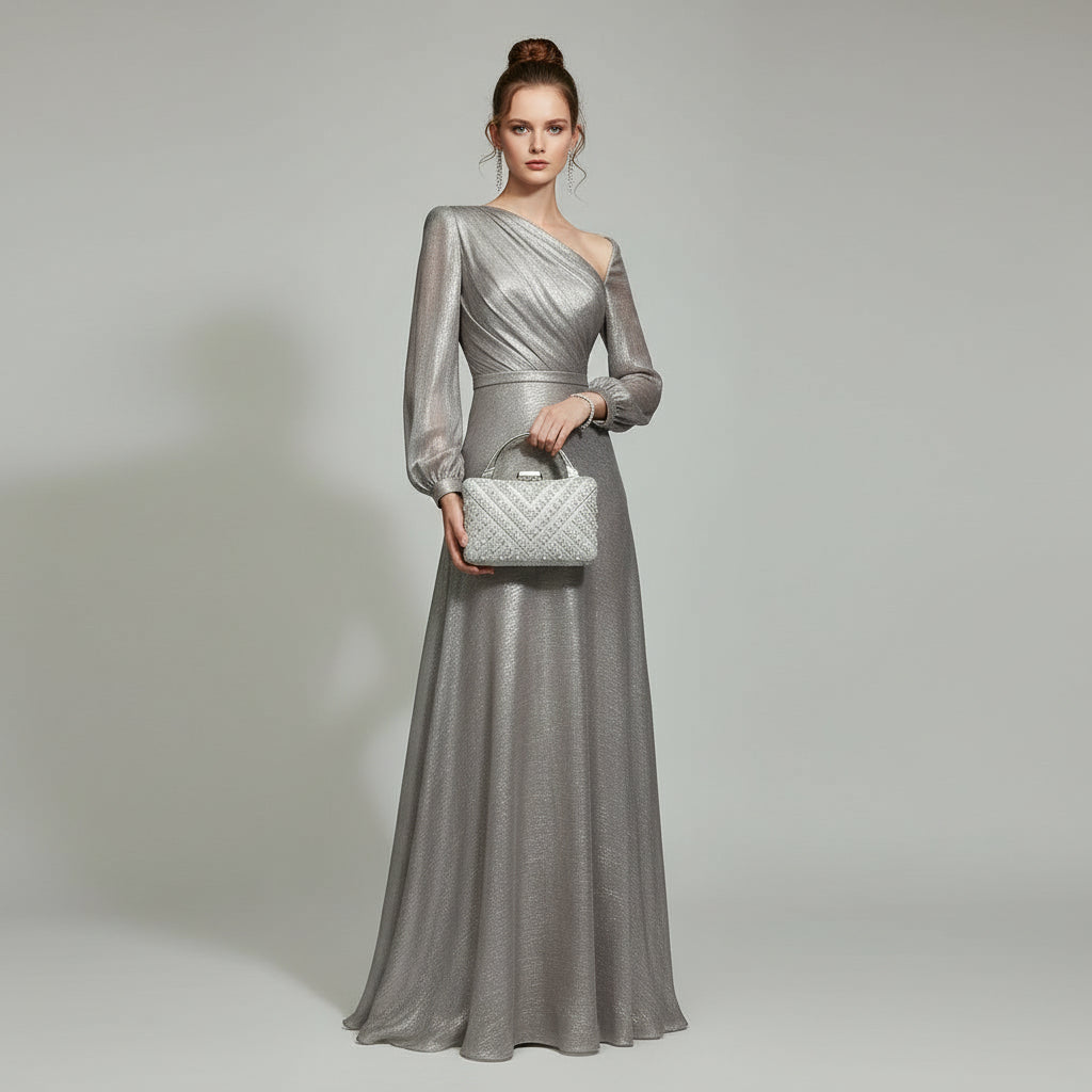 Silver handbag with rhinestone embellishments held by a hand against a light background