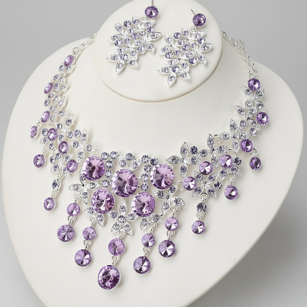 Jewelry set with purple and clear stones on a white stand