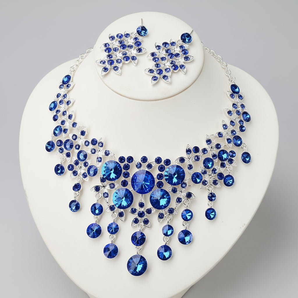Blue gemstone necklace and earrings on a white stand