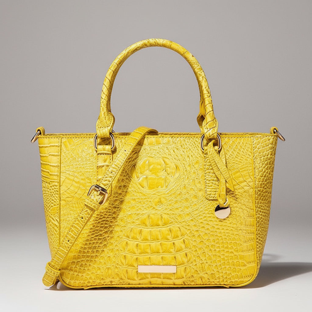 Yellow textured handbag on a wooden surface with a dark background
