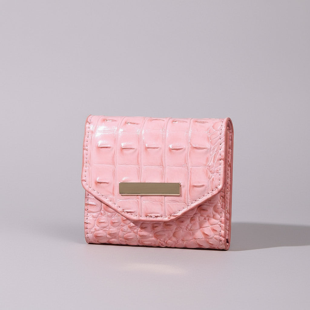 Pink textured wallet with a gold accent on a neutral background