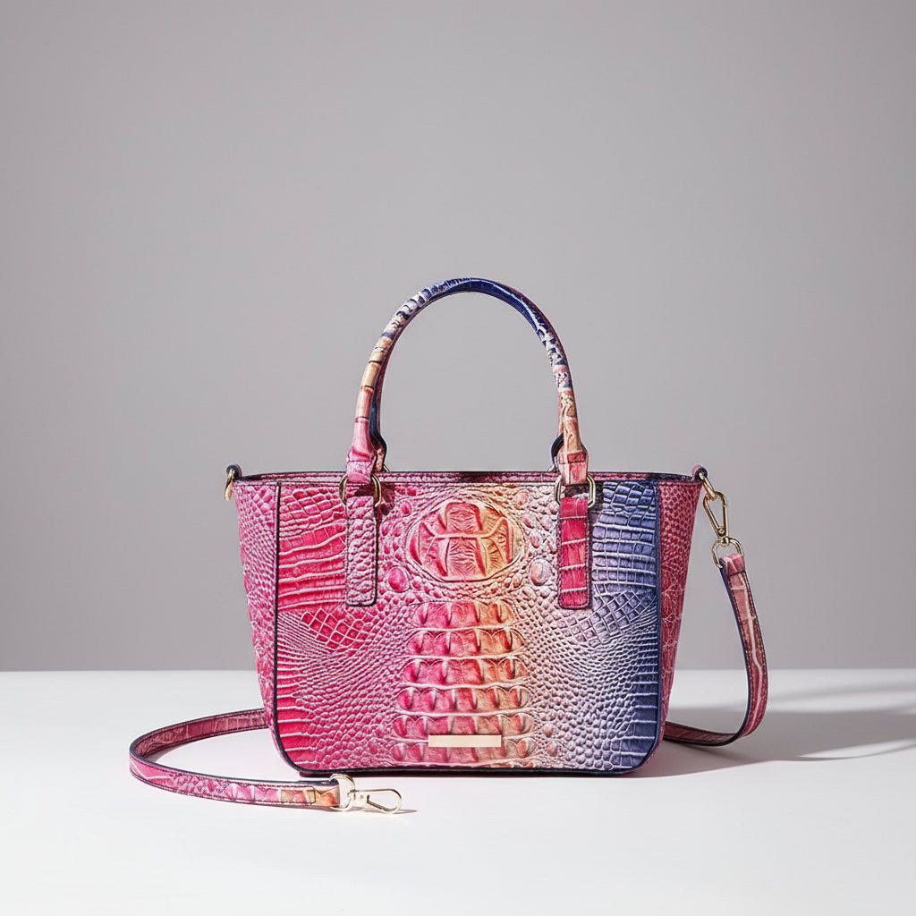 Pink crocodile-patterned handbag with a strap on a dark background