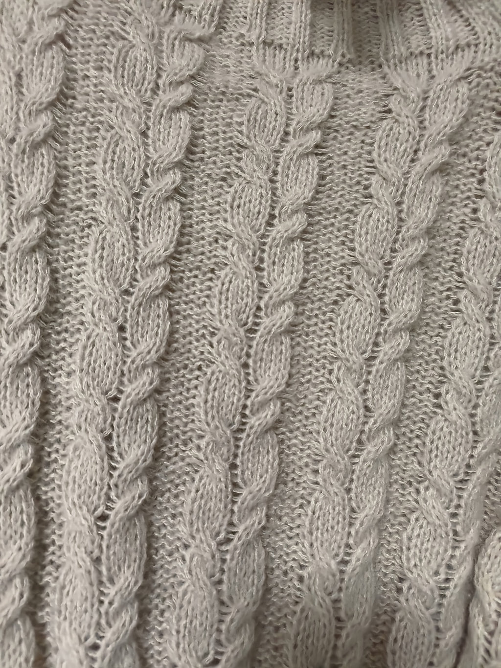 Close-up of a textured gray fabric with braided pattern