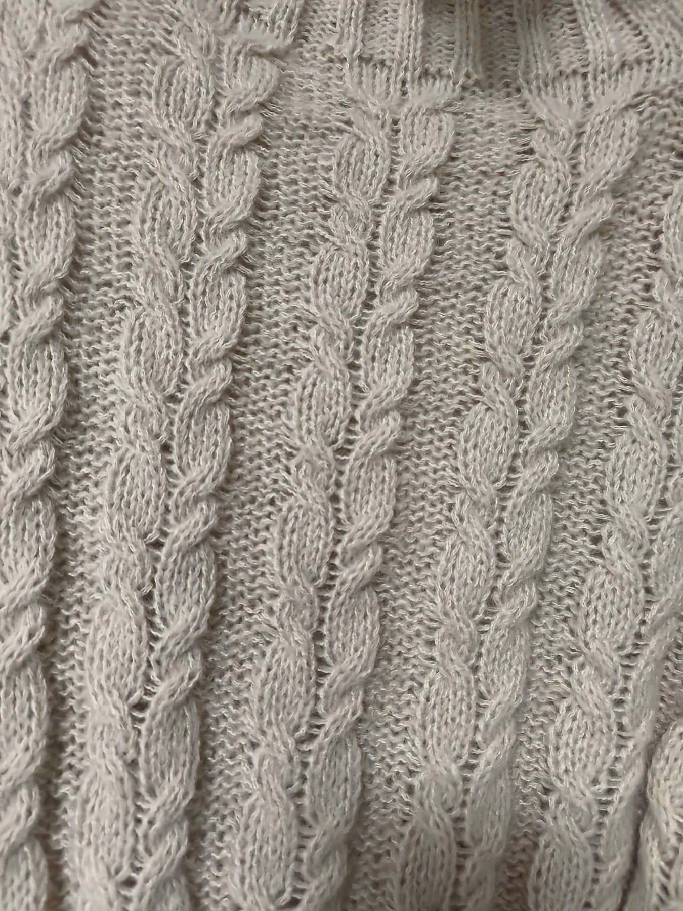 Close-up of a textured gray fabric with braided pattern