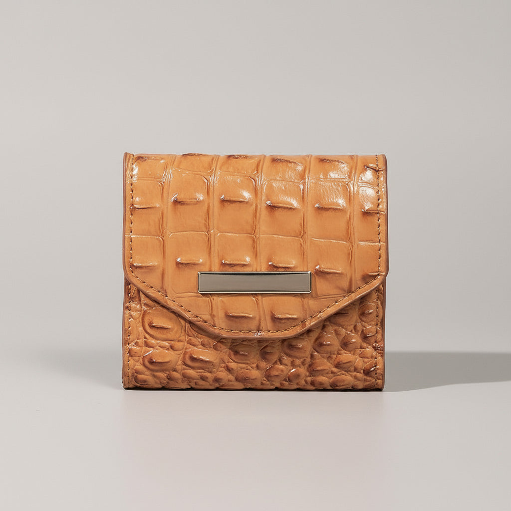 Brown textured wallet on a light surface with a dark background