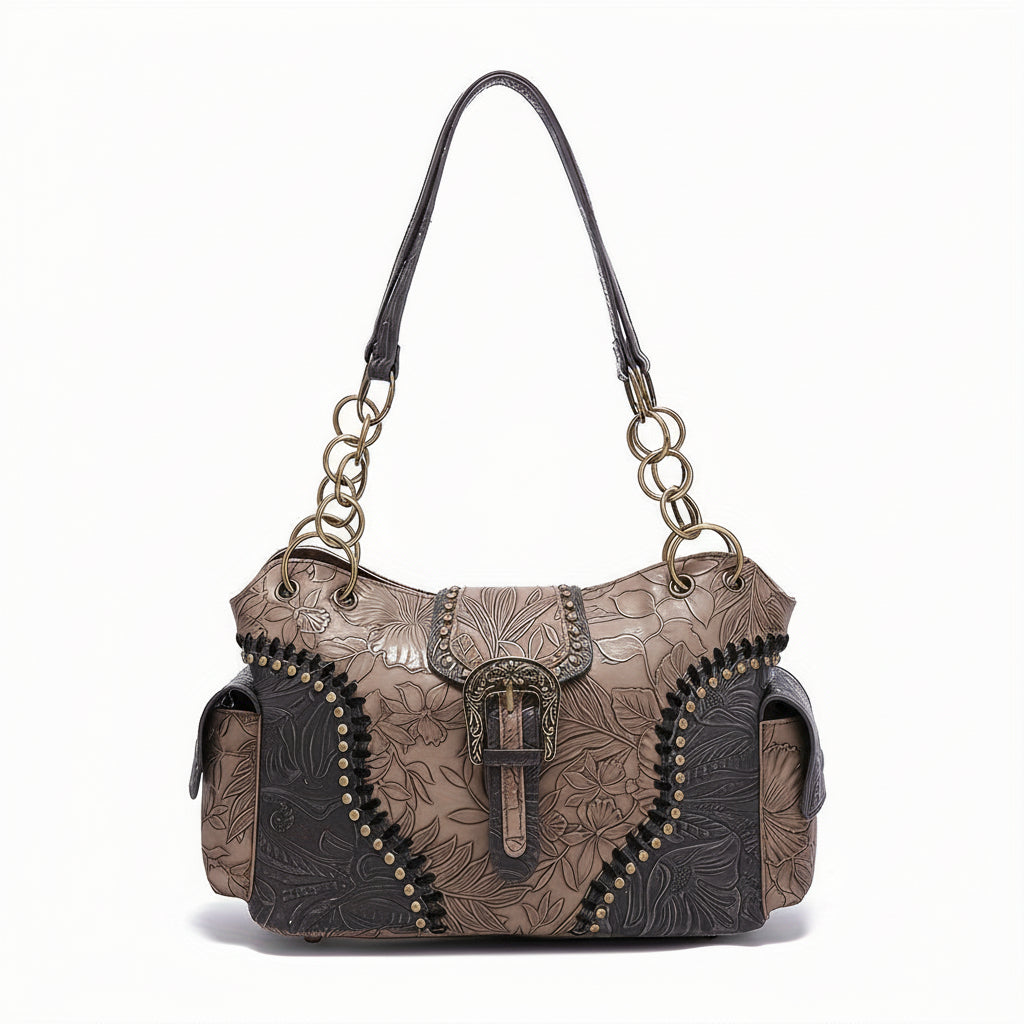 Brown leather handbag with floral patterns and gold accents on a white background