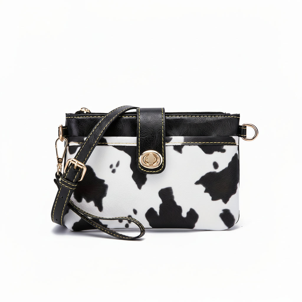 Handbag with cow print pattern on a white background