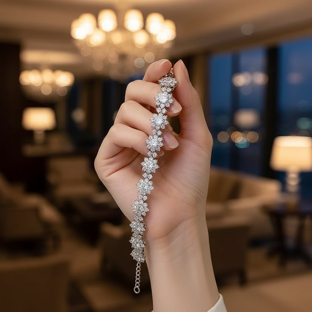 Silver bracelet with clear stones held by a hand against a blurred background