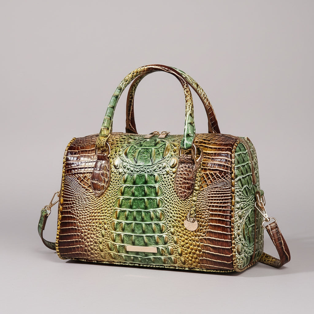 Green and brown crocodile skin handbag on a dark background