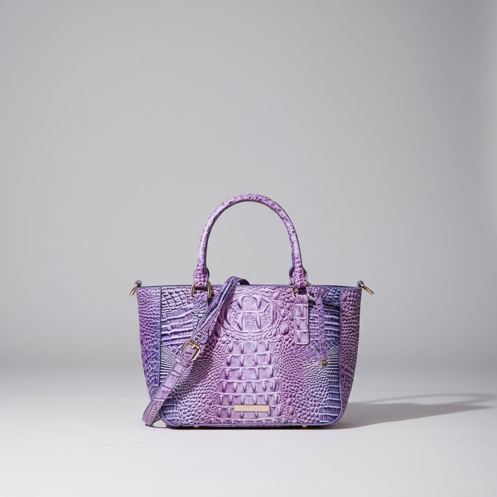 Purple textured handbag with a matching strap on a neutral background