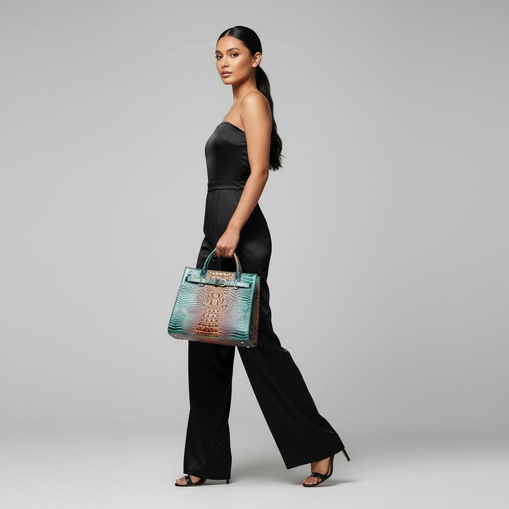 Woman holding a green handbag against a gray background