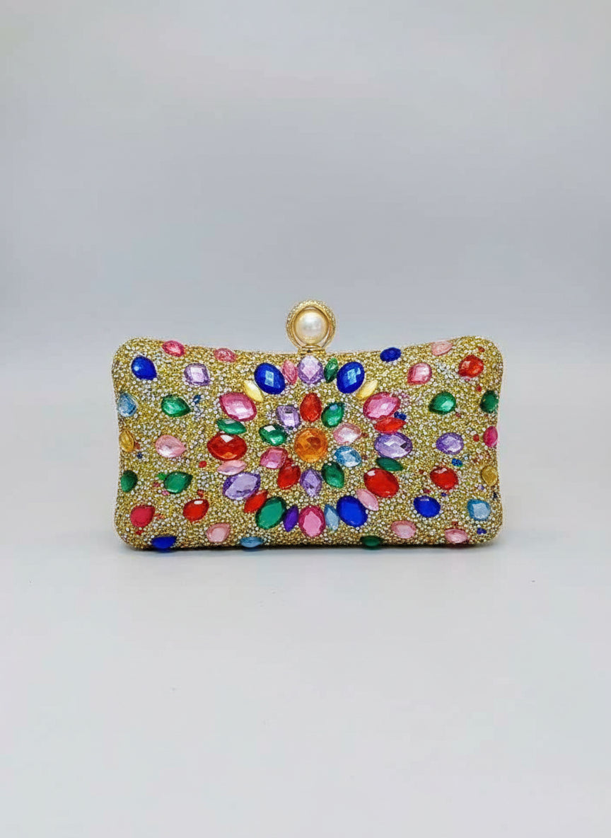 Colorful gemstone clutch held by a person against a neutral background