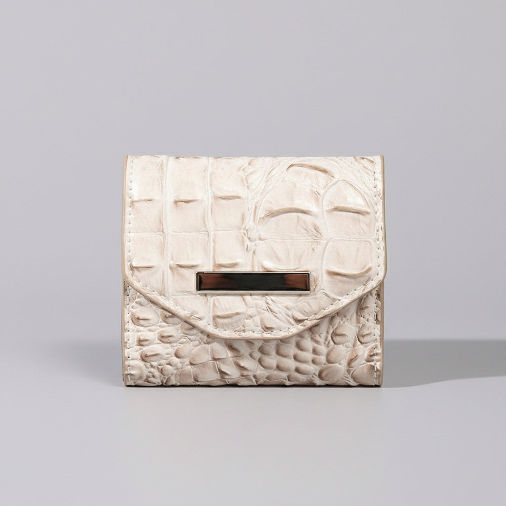 White textured wallet with a gold buckle on a light gray surface.