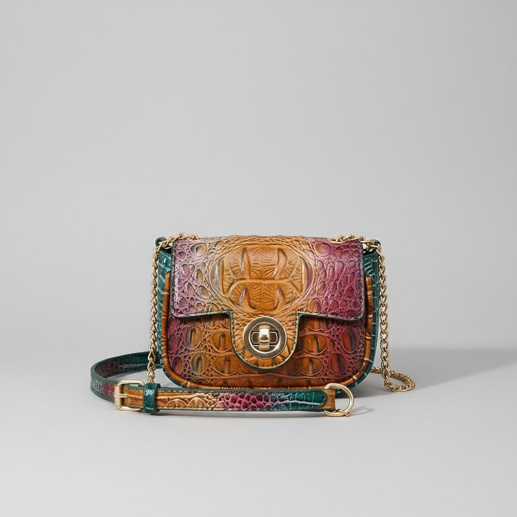Multicolored leather handbag with embossed patterns on a wooden surface