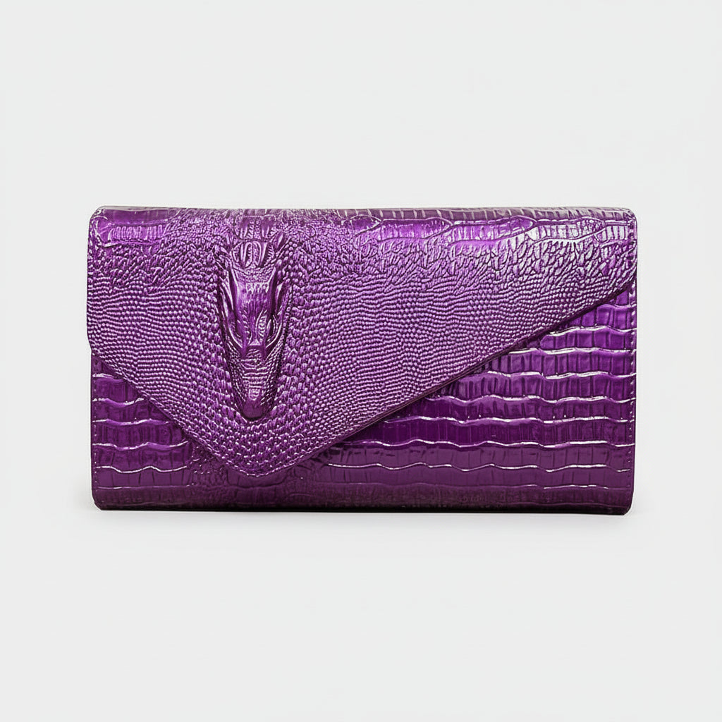Purple crocodile-textured clutch bag on a white background