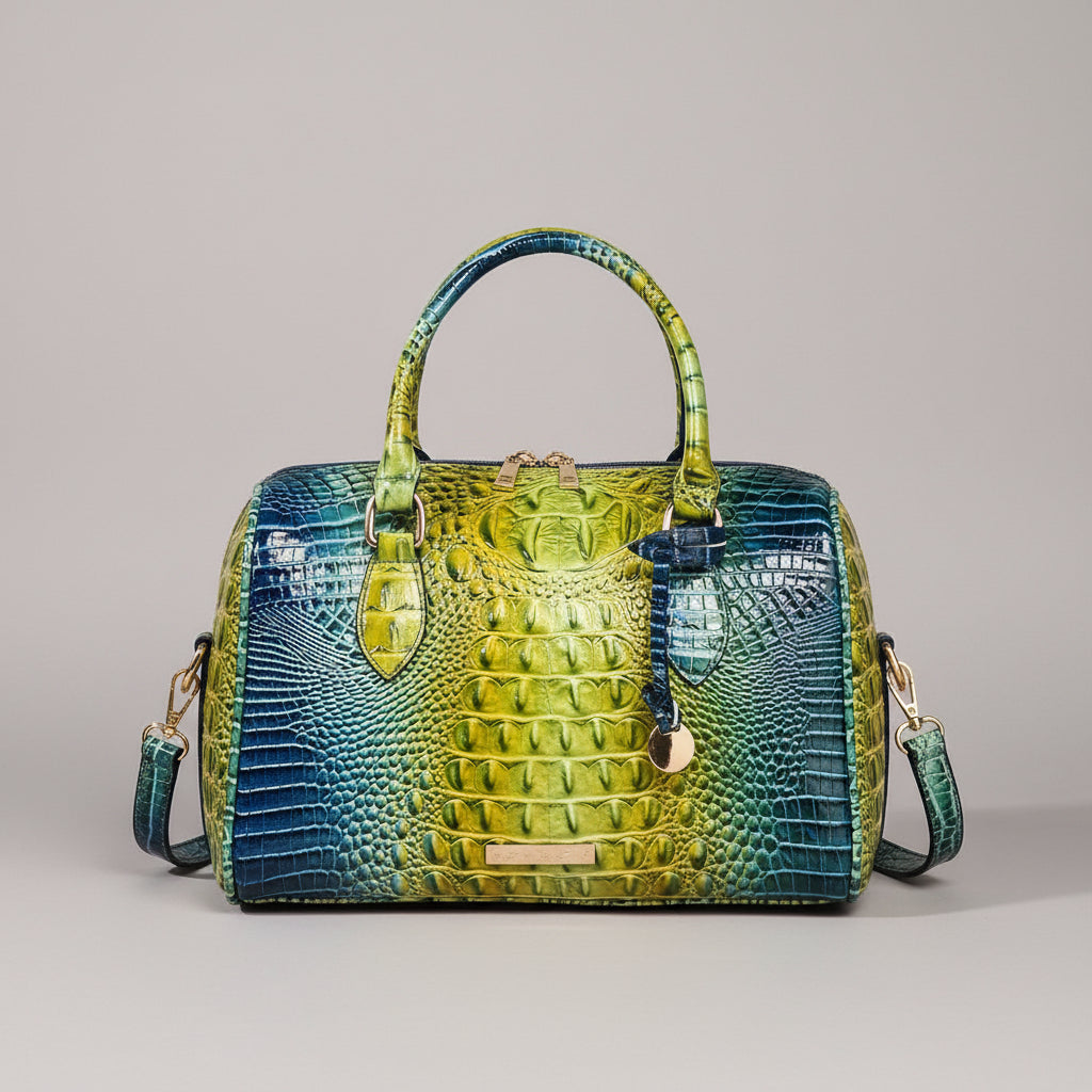 Blue and green handbag with crocodile pattern on a dark background