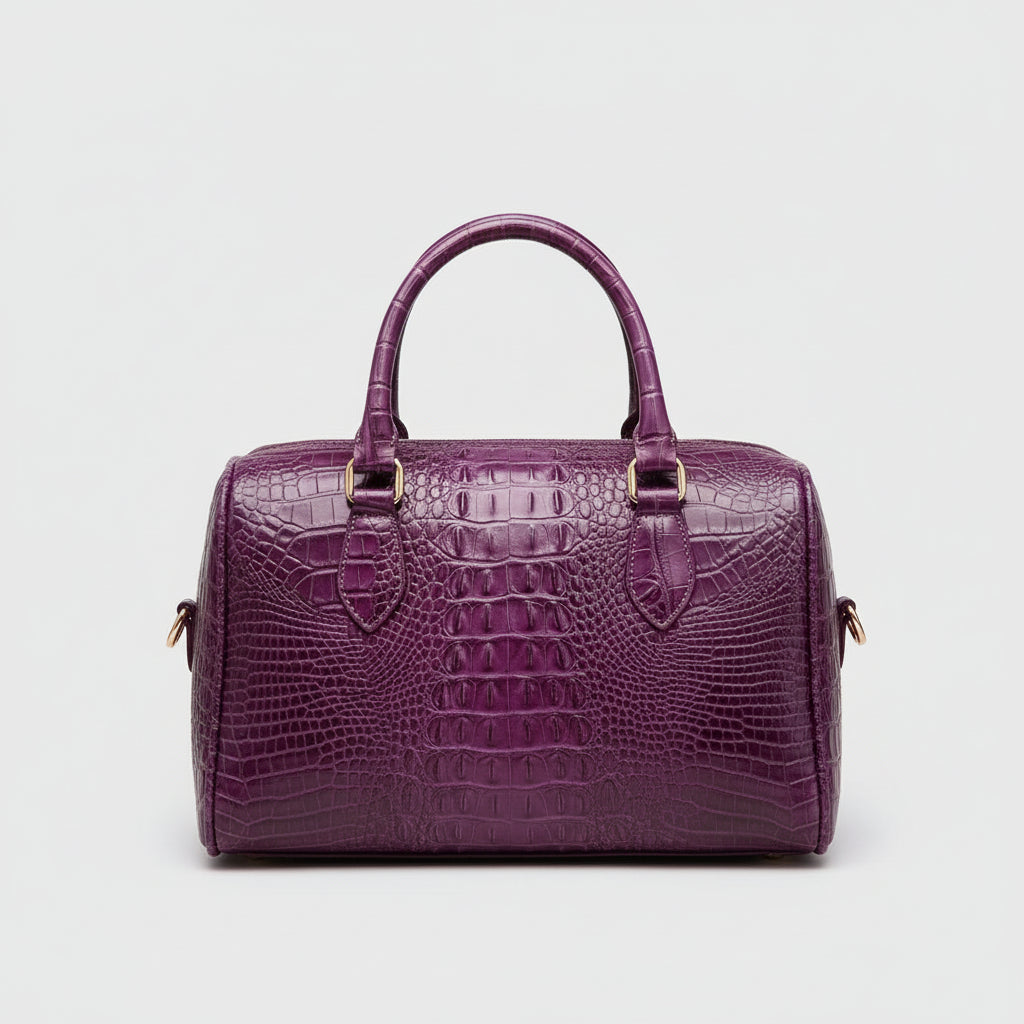 Purple crocodile-patterned handbag on a dark background