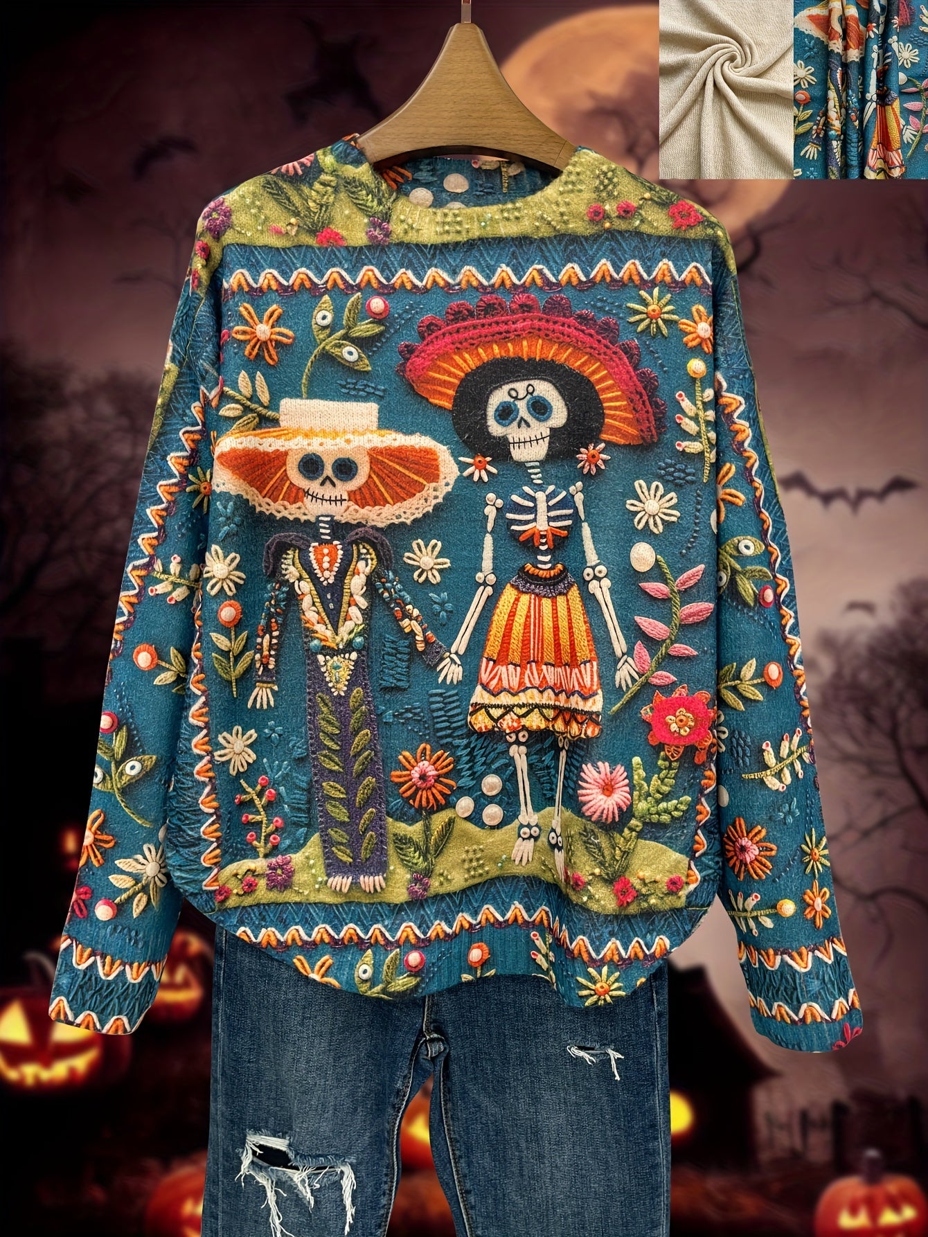 Colorful embroidered sweater with skeleton design on a hanger against a Halloween-themed background.