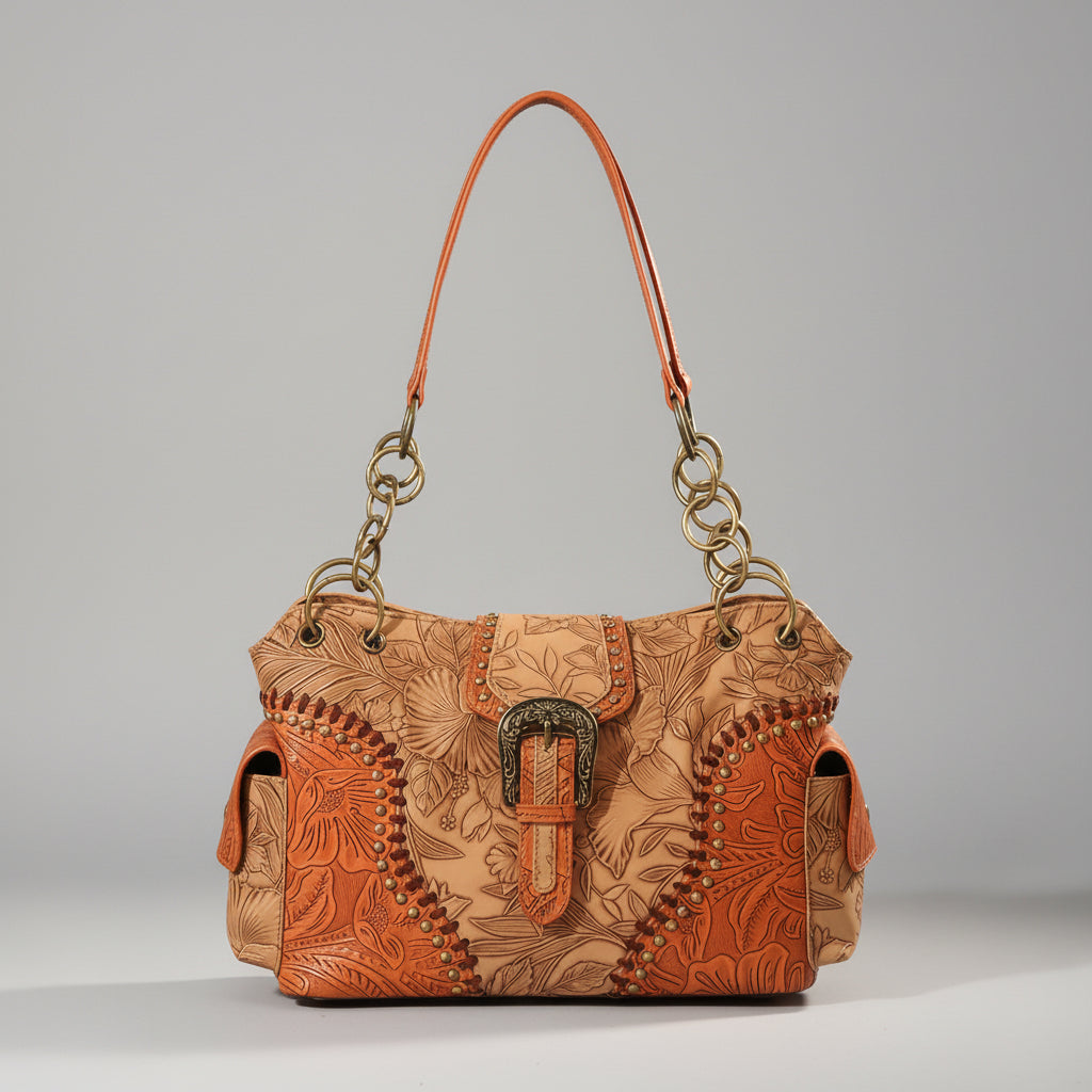 Brown leather handbag with intricate patterns on a wooden surface