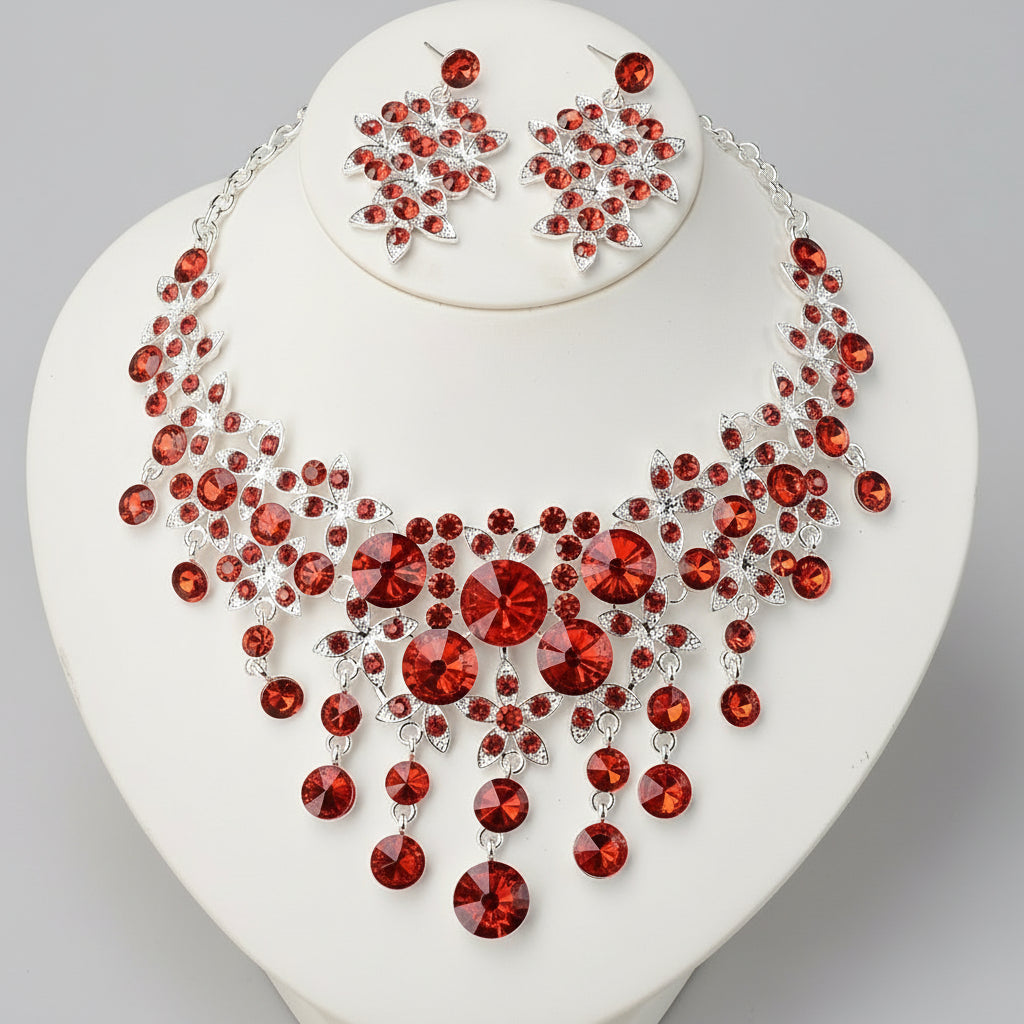 Jewelry set with red gemstones on a white heart-shaped stand