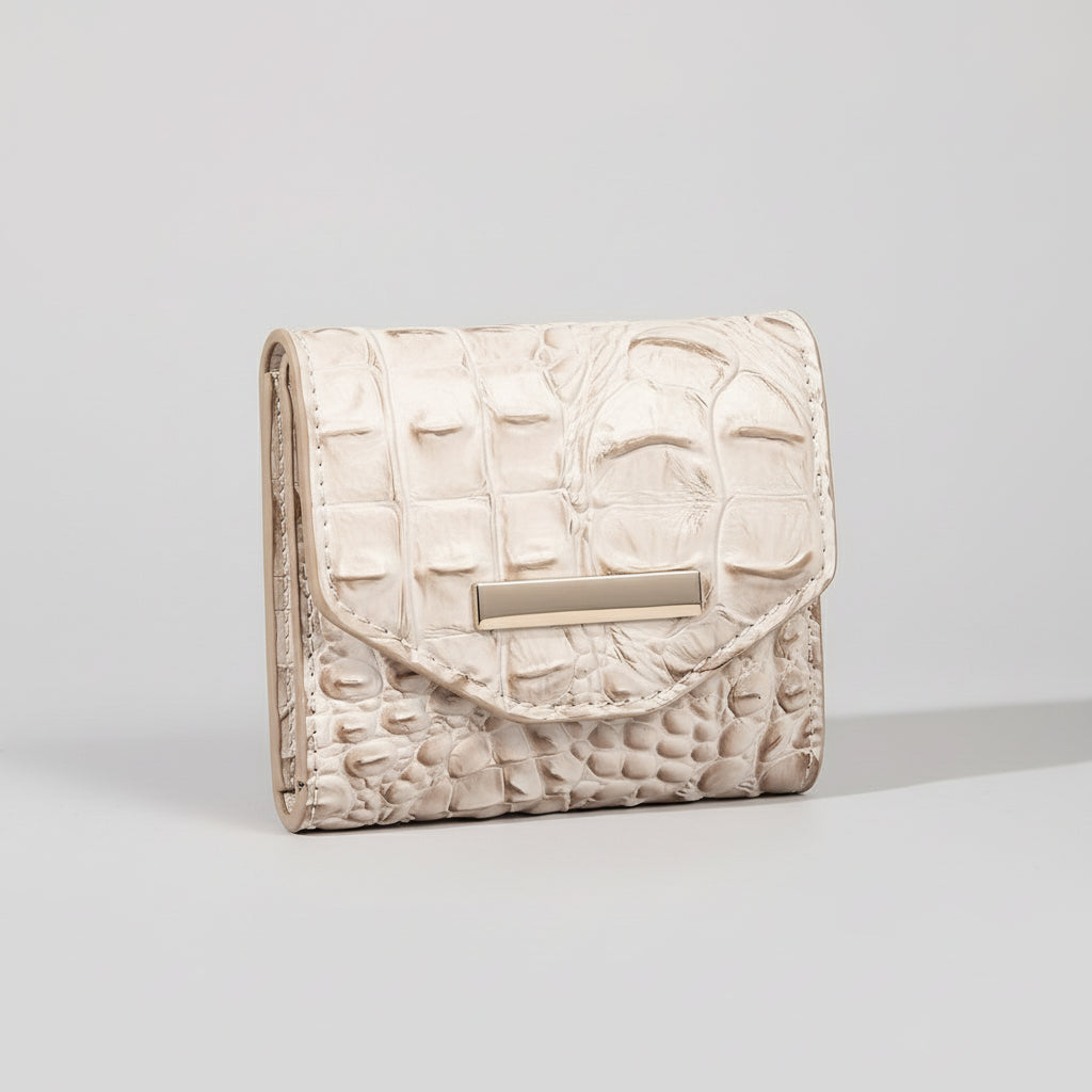 White textured wallet with a gold clasp on a textured surface