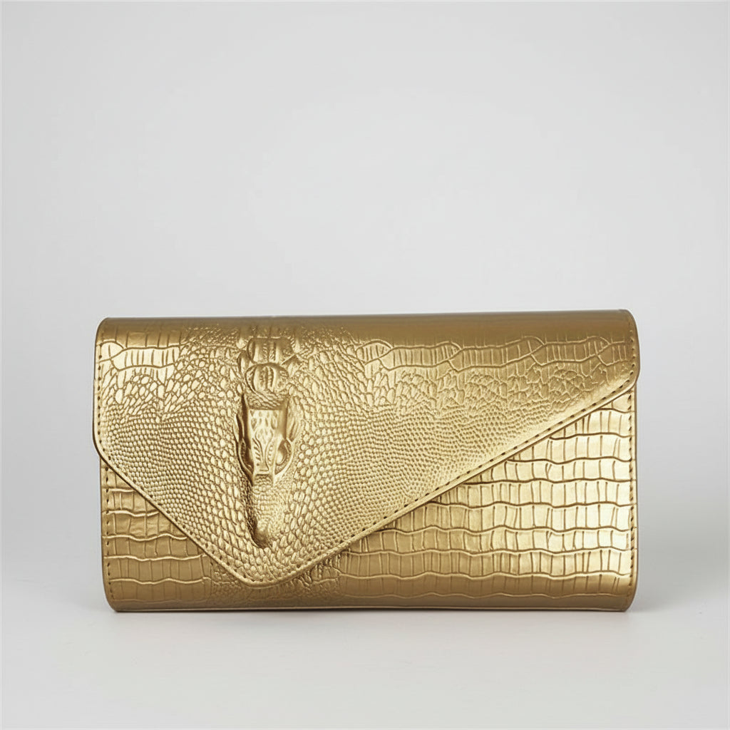 Gold clutch with snake design on a white background