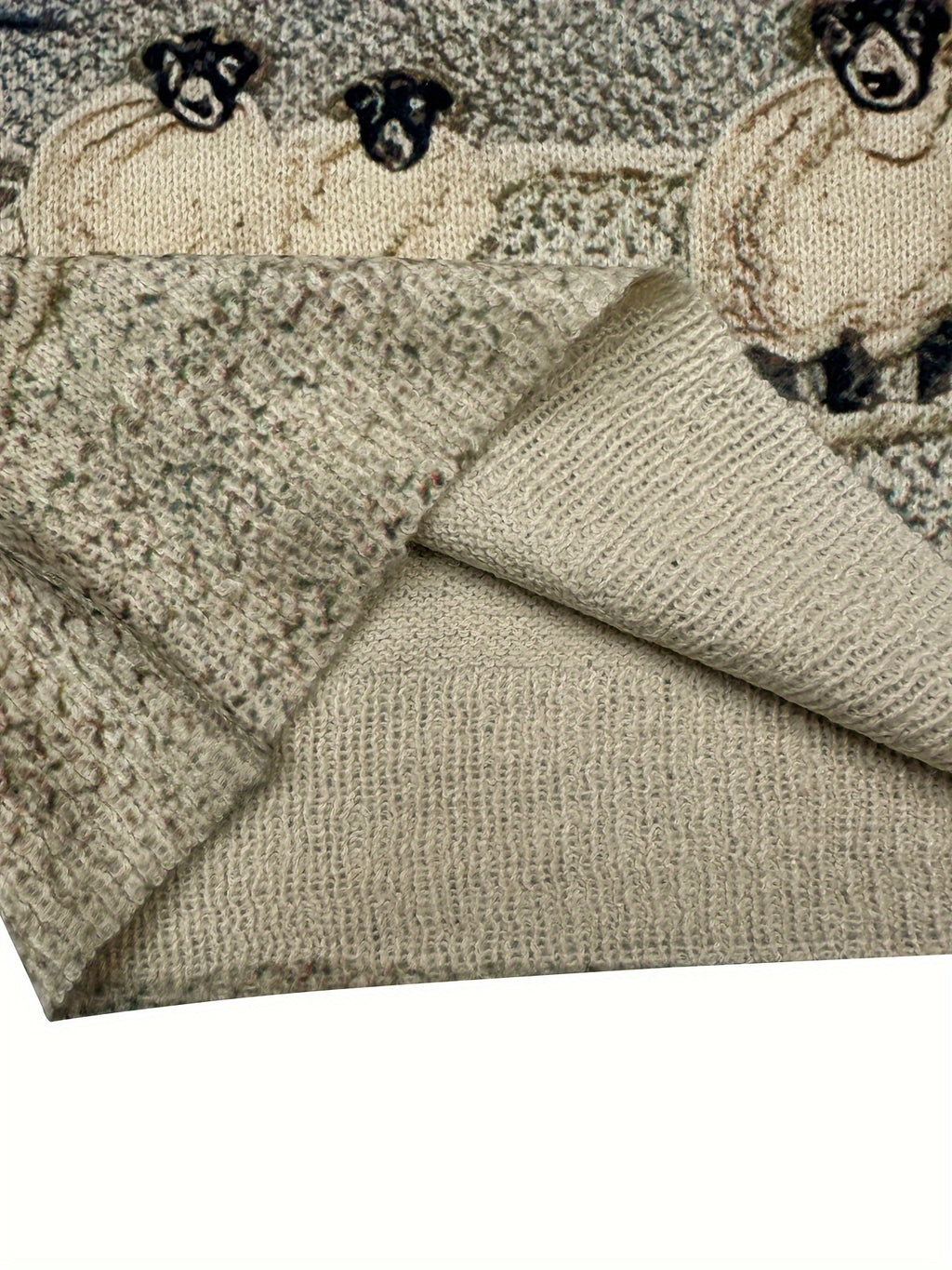 Textured fabric with embroidered sheep design on a white background