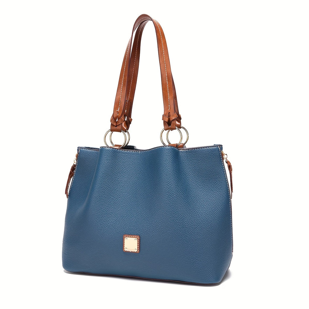 Blue handbag with brown handles and accents on a white background